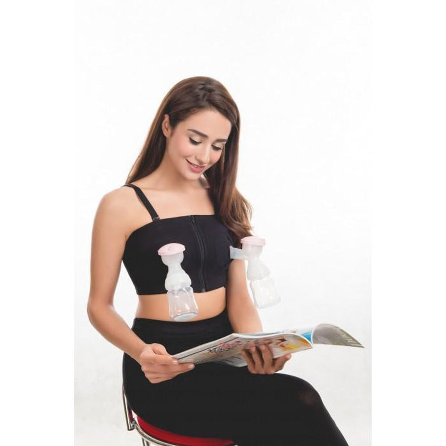Isa Uchi hands free breast pump bra in black, worn with two pump flanges in place