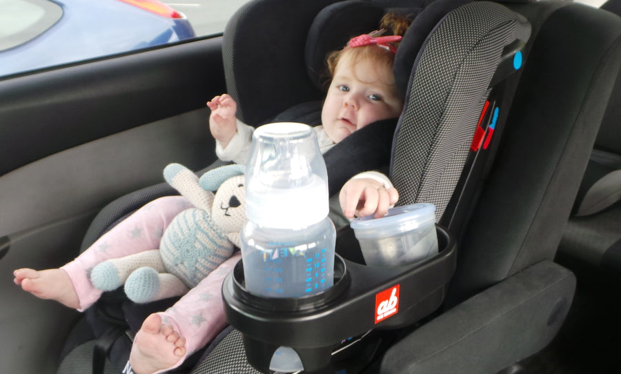 ab New Zealand portable snack and drink holder fitted to a car seat