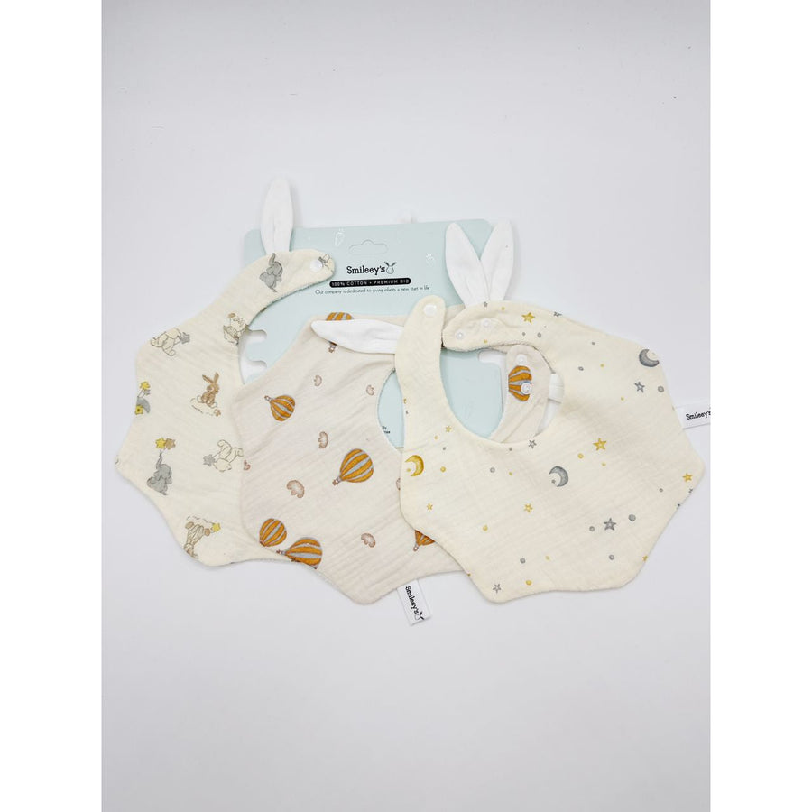 Smileey's 3pcs baby waterproof bib set - three cotton muslin bibs with bunny-ear detail in animal, hot-air balloon and star prints on a Smileey's branded card