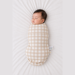 Baby sleeping in the Count & Countess Swaddle Bag, Oat Gingham