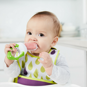 Baby using the b.box Fresh Food Feeder in Apple