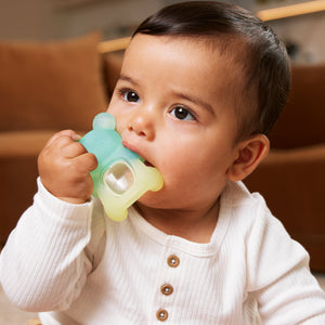 Baby chewing an Infantino gummy bear teether