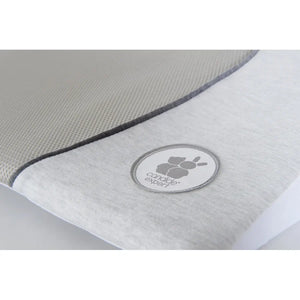 Baby lying on the Candide Air+ 15 degree cot wedge