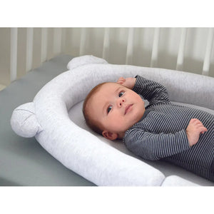 Baby resting in the Candide Air+ Baby Nest inside a moses basket