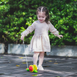 Child pulling the PlanToys Snail along