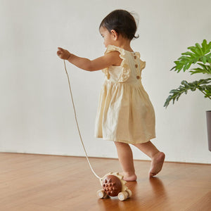 Child walking with the PlanToys Pull-Along Hedgehog