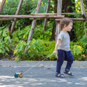 Toddler pulling the PlanToys Hopping Rabbit