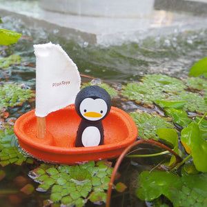PlanToys Penguin Sailing Boat floating in water
