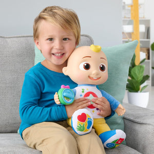 Child holding Cocomelon Discover N Play JJ plush
