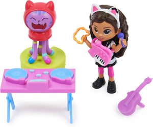 Gabby holding the kitty keyboard beside the DJ turntable