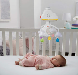 Baby sleeping under the Calming Clouds cot mobile