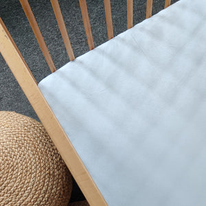 Candide cotton jersey fitted sheet 60x120 cm in sky blue on a cot mattress