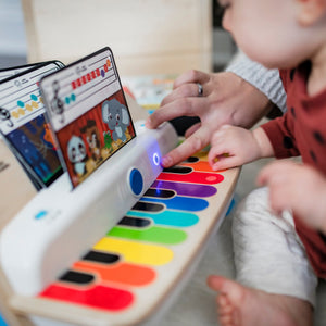Toddler playing the Together in Tune wooden piano keys