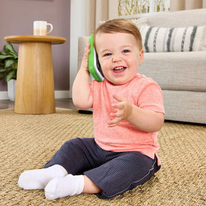 Baby holding the LeapFrog Ring & Record Learning Phone to their ear
