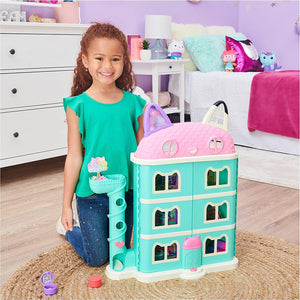 Child standing beside the dollhouse to show its size