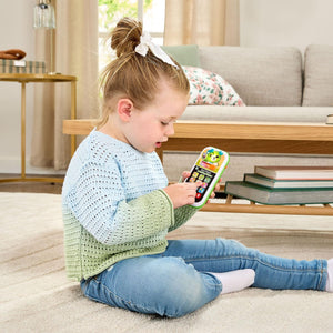 Toddler pressing the buttons on the LeapFrog learning phone