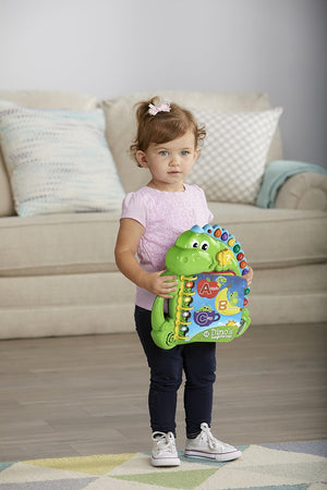 Toddler carrying the LeapFrog Dino's Delightful Day Book