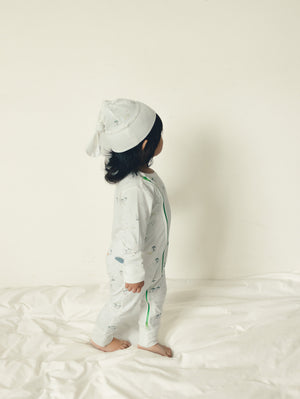 Baby wearing the Hamako Tencel Jippa Suit in the Farmyard print