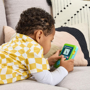 Child playing the LeapFrog Preschool Game & Go on a sofa