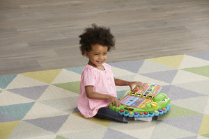Toddler pressing the buttons on LeapFrog Dino's Delightful Day Book