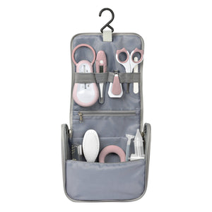 BEABA grey toiletry bag opened and hanging with all 9 old-pink accessories in place