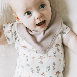 Baby wearing the Kays+Kins Magic Grove print bandana bib