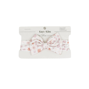 Baby wearing the Kays+Kins Blooming Lullaby print pre-tied bow headband