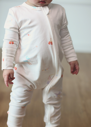 Baby wearing Twinkle Planet Circus Dino onepiece