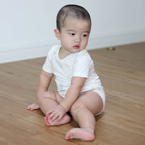 Baby wearing Twinkle Planet organic cotton short sleeve bodysuit