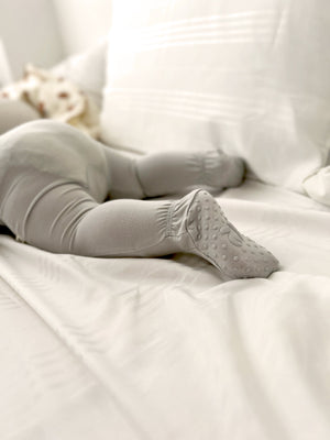 Baby wearing Number Twelve Bamboo Footies in Stone