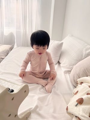 Baby wearing Number Twelve Bamboo Footies in Bloom