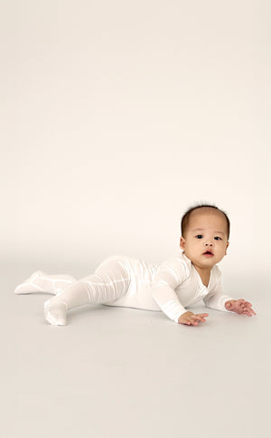 Baby wearing Number Twelve Bamboo Footies in Snow