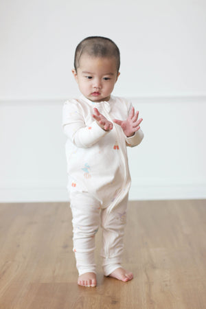 Child wearing Twinkle Planet Circus Dino organic cotton onepiece