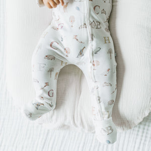 Footed legs of the Kays+Kins Organic Growsuit in the Letter Animals print