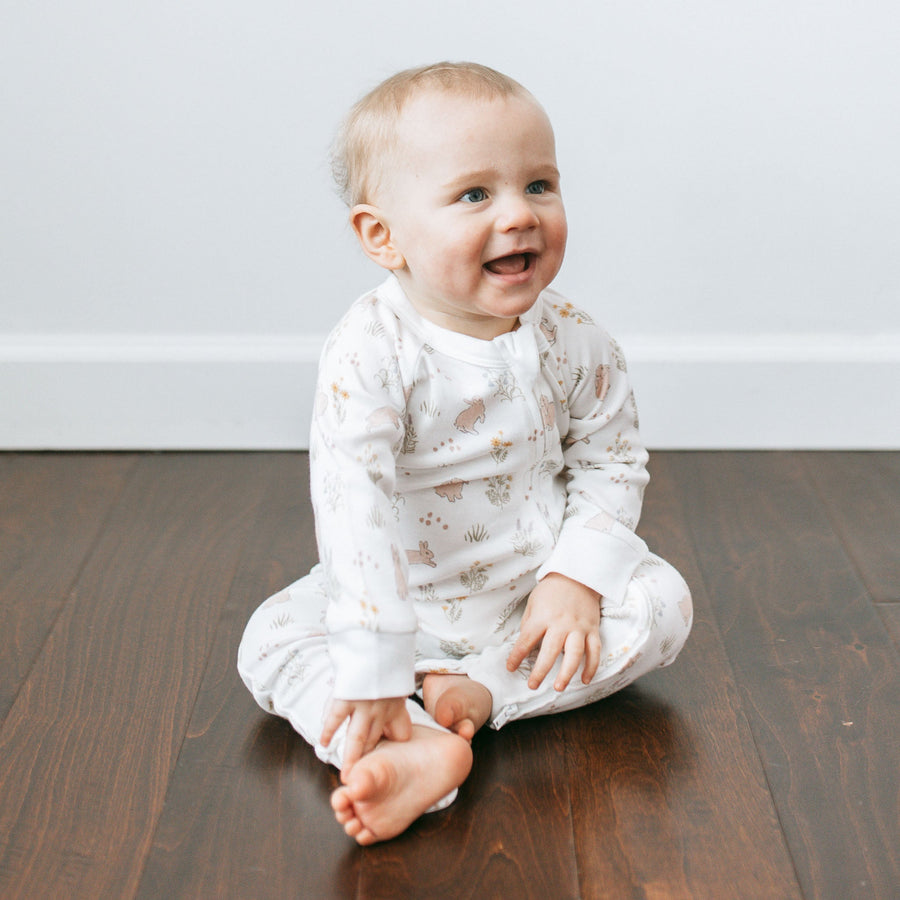 Kays+Kins Organic Growsuit in the Springhop rabbit print, worn by a baby