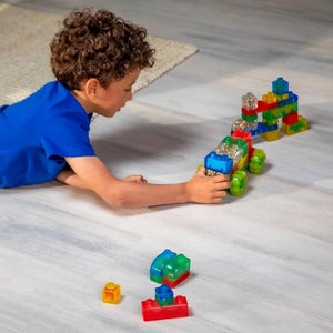 Child building with Jelly Blox squishy blocks and rolling truck