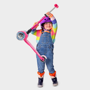 Child with Micro Mini Foldable LED scooter in pink