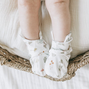 Baby wearing Kays+Kins Magic Grove print mitts and booties