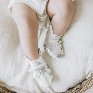 Baby wearing Kays+Kins Woodland print mitts and booties