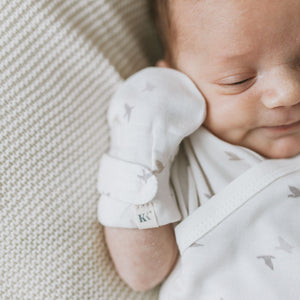 Baby wearing Kays+Kins Avian print mitts and booties