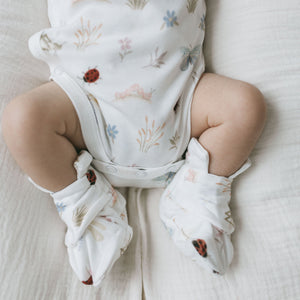 Baby wearing Kays+Kins Bugsy print mitts and booties