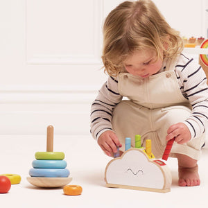 Toddler playing with Le Toy Van Rainbow Cloud Pop-up Toy