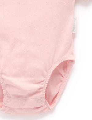 Purebaby Pointelle Ruffle Bodysuit - Guava - snap clips at the leg