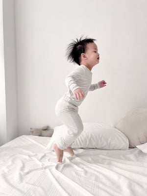 Toddler wearing Number Twelve Bamboo Pyjamas in Stone