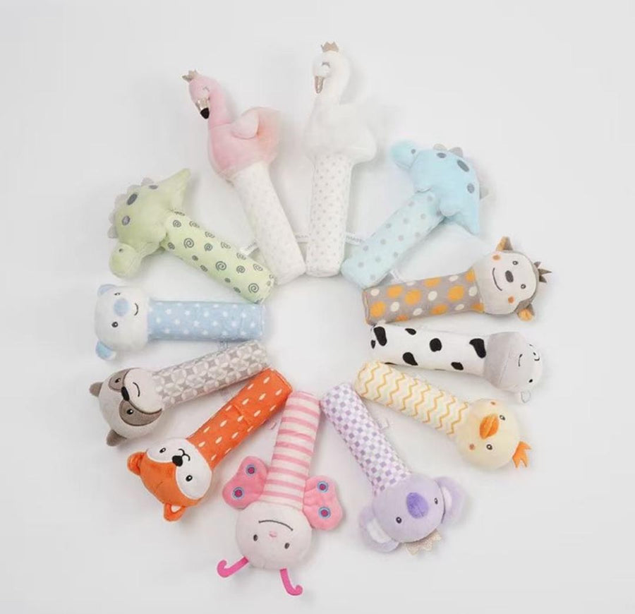 Smileey's Squeaky Toy assortment - thirteen plush squeaker sticks arranged in a ring, including flamingo, swan, dinosaur, fox, koala, chick and butterfly designs