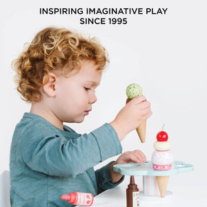 Child playing with Le Toy Van wooden ice cream stand