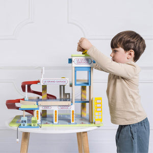 Child playing with Le Toy Van Le Grand Garage