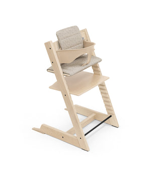 Stokke Tripp Trapp Cushion in Beige Timber shown on a chair with Baby Set