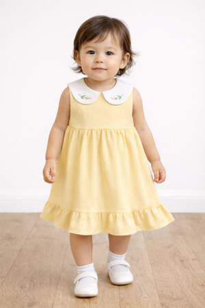 Toddler wearing Twinkle Planet Custard Yellow sleeveless dress
