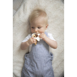 Baby holding the Sophie la girafe silhouette teething rings